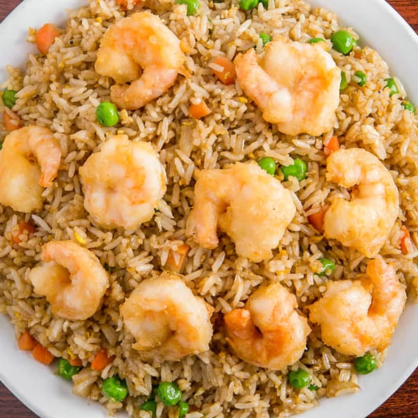 Close-up of Louisiana Famous Fried Chicken's shrimp fried rice with peas and carrots.