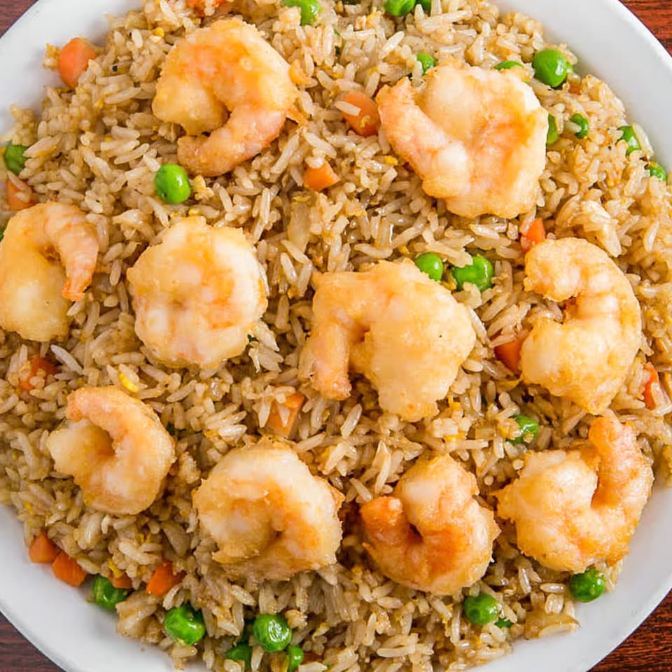 Close-up of Louisiana Famous Fried Chicken's shrimp fried rice with peas and carrots.